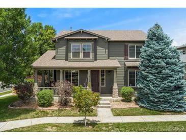 Charming two-story home with a covered front porch and well-manicured lawn at 10550 Sedalia St, Commerce City, CO 80022