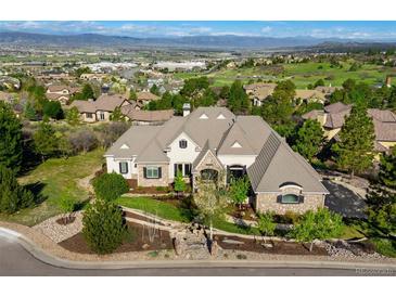 Stunning aerial view of a grand estate home with lush landscaping and mountain views at 4541 Tierra Alta Dr, Castle Rock, CO 80104
