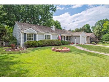 Charming single-story home featuring well-maintained lawn, lush landscaping and a welcoming curb appeal at 3225 S Race St, Englewood, CO 80113