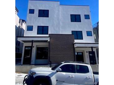 Modern two-story duplex with clean lines and dark brick accents at 1252 Yates St, Denver, CO 80204