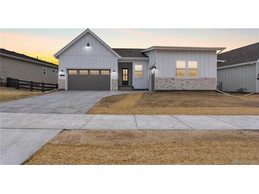 Charming single Gathering home featuring a 2-car garage and stone accents at 7392 Timberstone St, Castle Pines, CO 80108