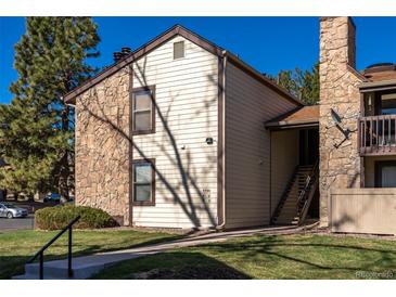 Charming condo with a mix of stone and siding, complemented by well-maintained landscaping and a clear blue sky at 7790 W 87Th Drive Dr # D, Arvada, CO 80005