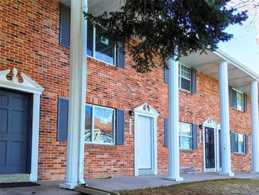 Brick building with gray doors and white columns at 14023 E Utah Cir, Aurora, CO 80012