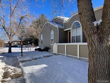 Tan exterior of home with snow on ground at 5866 W Asbury Pl, Lakewood, CO 80227