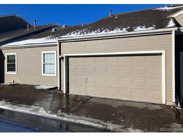 Attached two-car garage providing convenience and secure parking at 5866 W Asbury Pl, Lakewood, CO 80227