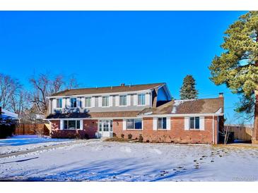 Brick ranch home with snow-covered lawn at 6279 E Princeton Ave, Cherry Hills Village, CO 80111