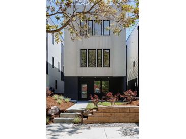 Contemporary two-story home featuring a modern design with a beautifully landscaped front yard at 2738 N Clay St, Denver, CO 80211