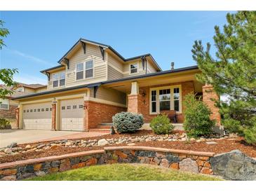 Charming two-story home featuring a well-manicured front yard and a two-car garage, plus stone retaining wall at 7949 S Blackstone Pkwy, Aurora, CO 80016