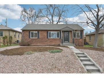 Charming brick home with landscaped front yard and concrete steps leading to the entrance at 1632 S Josephine St, Denver, CO 80210