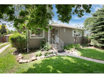 Charming single-story home with lush landscaping, front yard, and inviting entrance at 3061 S Marion St, Englewood, CO 80113