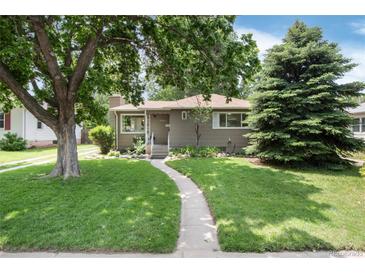 Charming single-story home with a well-manicured lawn and mature trees in a desirable neighborhood at 3061 S Marion St, Englewood, CO 80113
