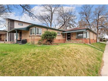 Charming single-story brick home featuring a well-manicured lawn and inviting curb appeal on a sunny day at 2259 Meade St, Denver, CO 80211