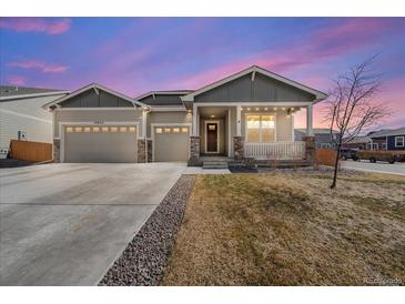 Charming single-Gathering home featuring a welcoming front porch and a spacious three-car garage at 14632 Longhorn Dr, Mead, CO 80542