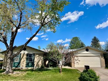Charming ranch home with a well-maintained lawn, mature trees, and a blue sky at 3026 S Alton Ct, Denver, CO 80231