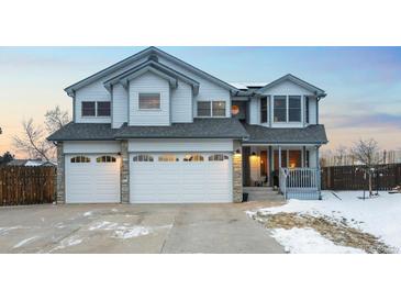 Charming two-story home with a three car garage, stone accents, covered front porch, and tasteful trim at 4286 S Cole St, Morrison, CO 80465