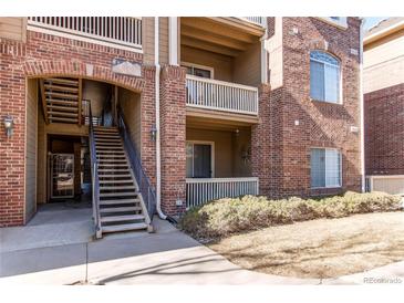 A brick apartment building with wooden balconies and exterior stairway at 1651 W Canal Cir # 613, Littleton, CO 80120