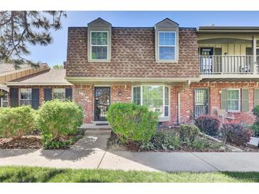 Charming brick townhouse with a well-maintained front yard and a cozy, inviting entrance at 8871 E Amherst Dr # B, Denver, CO 80231