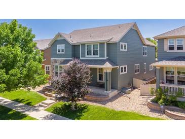 Charming two-story home with landscaped yard, porch, and a combination of stone and vinyl siding at 2488 Lake Vista Dr, Broomfield, CO 80023