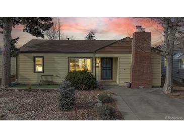 Charming yellow bungalow with landscaped yard and brick chimney at 1935 Nome St, Aurora, CO 80010