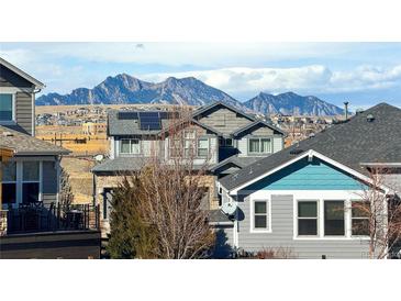 Beautiful multi-story home with solar panels against a scenic mountain backdrop at 8726 Gardenia Cir, Arvada, CO 80005