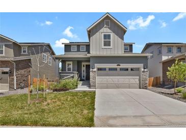 Charming two-story home with a two-car garage, landscaped yard, and welcoming front porch at 24555 E Ohio Dr, Aurora, CO 80018