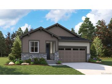 Charming single-Gathering home showcasing a stone facade, complemented by a well-manicured lawn and an attached two-car garage at 2657 Sawyer Ln, Erie, CO 80026