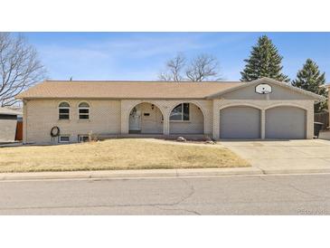 Charming single-story home with arched entryway, brick facade, and a two-car garage in a residential neighborhood at 2172 S Harlan St, Denver, CO 80227