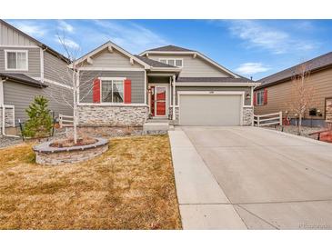 Charming two-story home featuring stone accents, a two-car garage, and a well-maintained front yard at 5190 Ditmars Trl, Castle Rock, CO 80104
