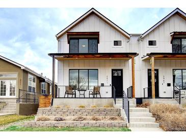 Charming two-story home with white siding, covered porch, and landscaped front yard offers great curb appeal at 2471 S High St, Denver, CO 80210