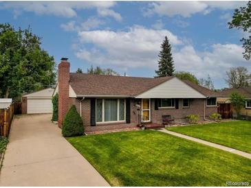 Charming brick ranch home with a well-manicured lawn and mature landscaping at 9115 W 5Th Ave, Lakewood, CO 80226