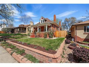 Charming red-brick home with manicured lawn and garden beds, showcasing classic architectural details and inviting curb appeal at 2772 Julian St, Denver, CO 80211