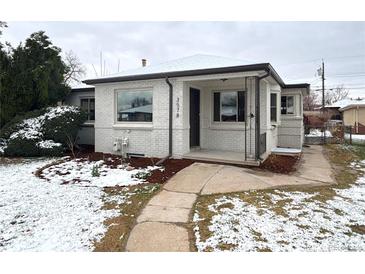 Charming single-story home with a brick exterior, landscaped yard, and welcoming entrance at 3578 Ivanhoe St, Denver, CO 80207
