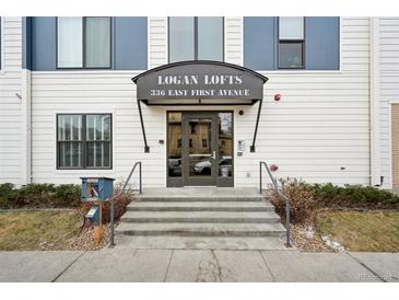 Exterior of the Logan Lofts building entrance, with a covered awning and clear signage for easy identification at 336 E 1St Ave # 207, Denver, CO 80203