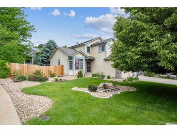Attractive home featuring a lush green lawn, mature trees, and a charming, well-maintained facade at 12705 Home Farm Dr, Westminster, CO 80234