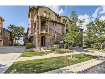 Stunning multi-story townhome features a stone facade, balcony and professional landscaping at 3491 Cascina Pl # D, Highlands Ranch, CO 80126