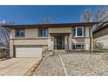 Charming two-story home with a well-manicured lawn and attached garage at 2269 S Yank Ct, Lakewood, CO 80228