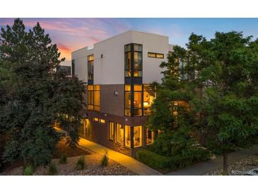 Modern townhome with large windows, brick accents, professional landscaping, and a contemporary design at 3220 Zuni St, Denver, CO 80211