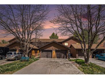 Charming townhome with an attached garage, mature trees and a spacious driveway at 718 Julian Cir, Lafayette, CO 80026