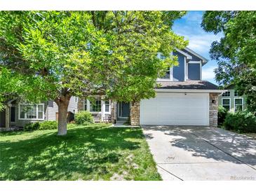 Charming home featuring a lush front yard, mature tree, and inviting curb appeal at 9682 Hemlock Ct, Highlands Ranch, CO 80130
