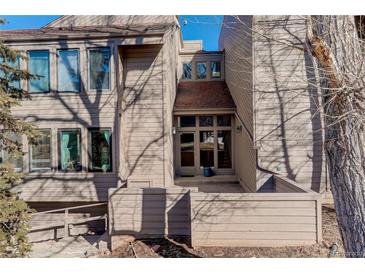 Inviting exterior of a multi-level condo with neutral siding, windows, and a welcoming entryway at 23634 Pondview Pl # B, Golden, CO 80401