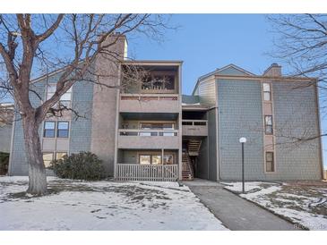 Exterior view of a two story building with snow on the ground at 14190 E Temple Dr # O-04, Aurora, CO 80015