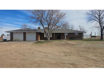 Charming brick home with an attached two car garage and spacious front yard at 2840 Wagner St, Strasburg, CO 80136