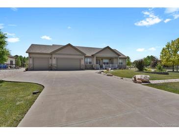 Lovely single-story home featuring a three-car garage and a well-manicured front yard at 4714 Carmichael Ct, Brighton, CO 80603