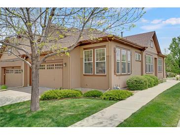 Charming one story home featuring a two car garage, lush green lawn, and mature landscaping at 12348 W Gould Ave, Littleton, CO 80127