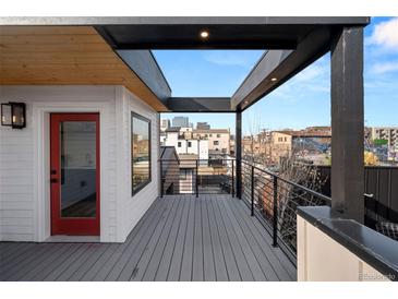 Spacious deck boasts city views, modern railings, and stylish overhang; perfect for outdoor enjoyment at 2451 Lawrence St # 2, Denver, CO 80205