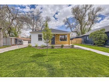 Charming home with a well-manicured front yard, new siding, and walkway leading to the front door at 4874 S Lincoln St, Englewood, CO 80113