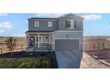 Charming two-story home with an attached two-car garage and covered front porch at 4548 River Highlands Loop, Elizabeth, CO 80107