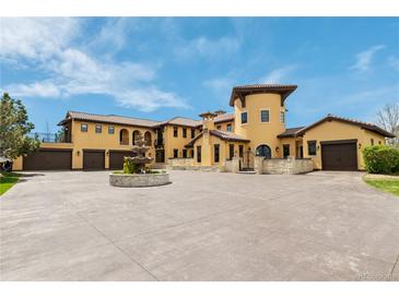 Stunning custom Mediterranean home featuring a grand entrance, fountain, and multiple garage spaces at 8417 High Ridge Ct, Castle Pines, CO 80108