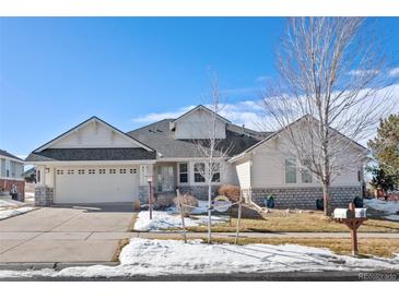 Two-story house with light-colored siding, stone accents, and a three-car garage at 7879 S Zante Ct, Aurora, CO 80016