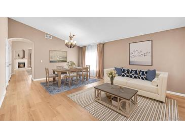 Bright living room featuring hardwood floors, modern furniture, and a view to the fireplace at 5162 Hubert St, Parker, CO 80134